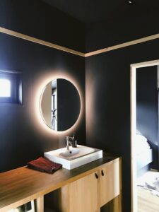 A sleek and contemporary Scandinavian bathroom with modern fixtures and ambient lighting.