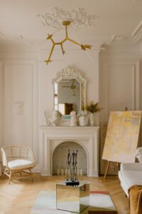 Luxurious living room interior featuring classic design with fireplace and art elements.