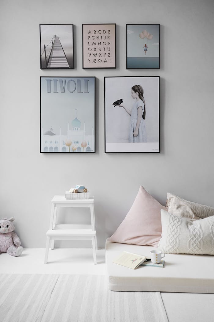 Minimalist Scandinavian bedroom with wall art and cozy decor elements.